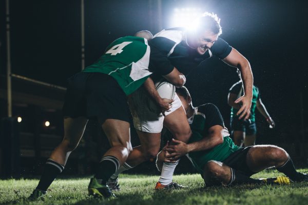 Rugby player trying to escape the tackle